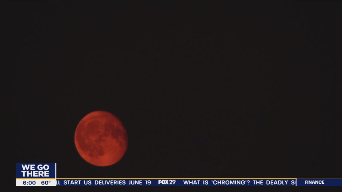 Smoke from Canadian wildfires gives moon a red glow